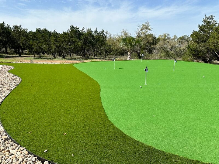 Custom multi-hole putting green with flags in the Texas Hill Country