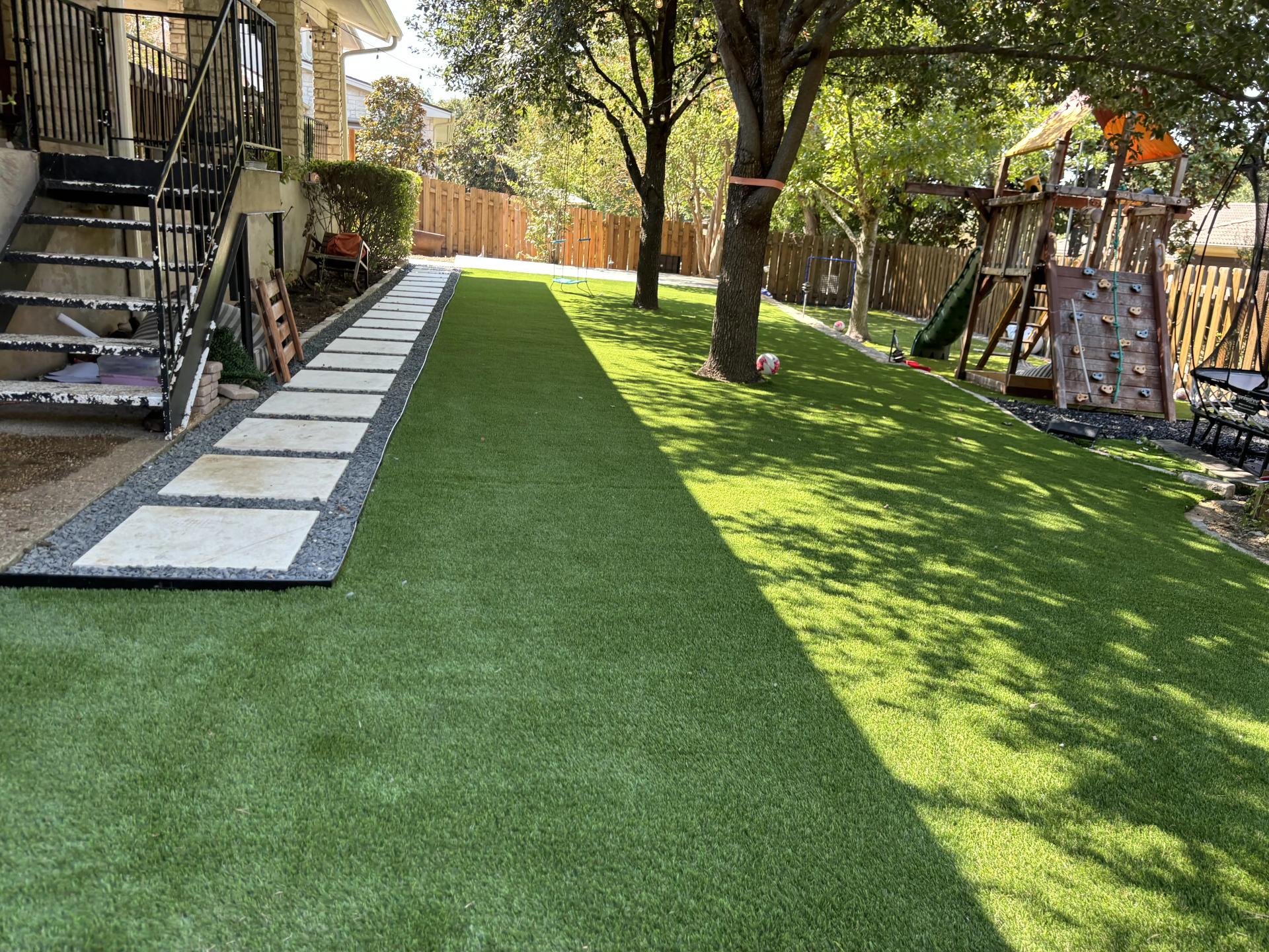 Artificial turf in a residential backyard with landscaping