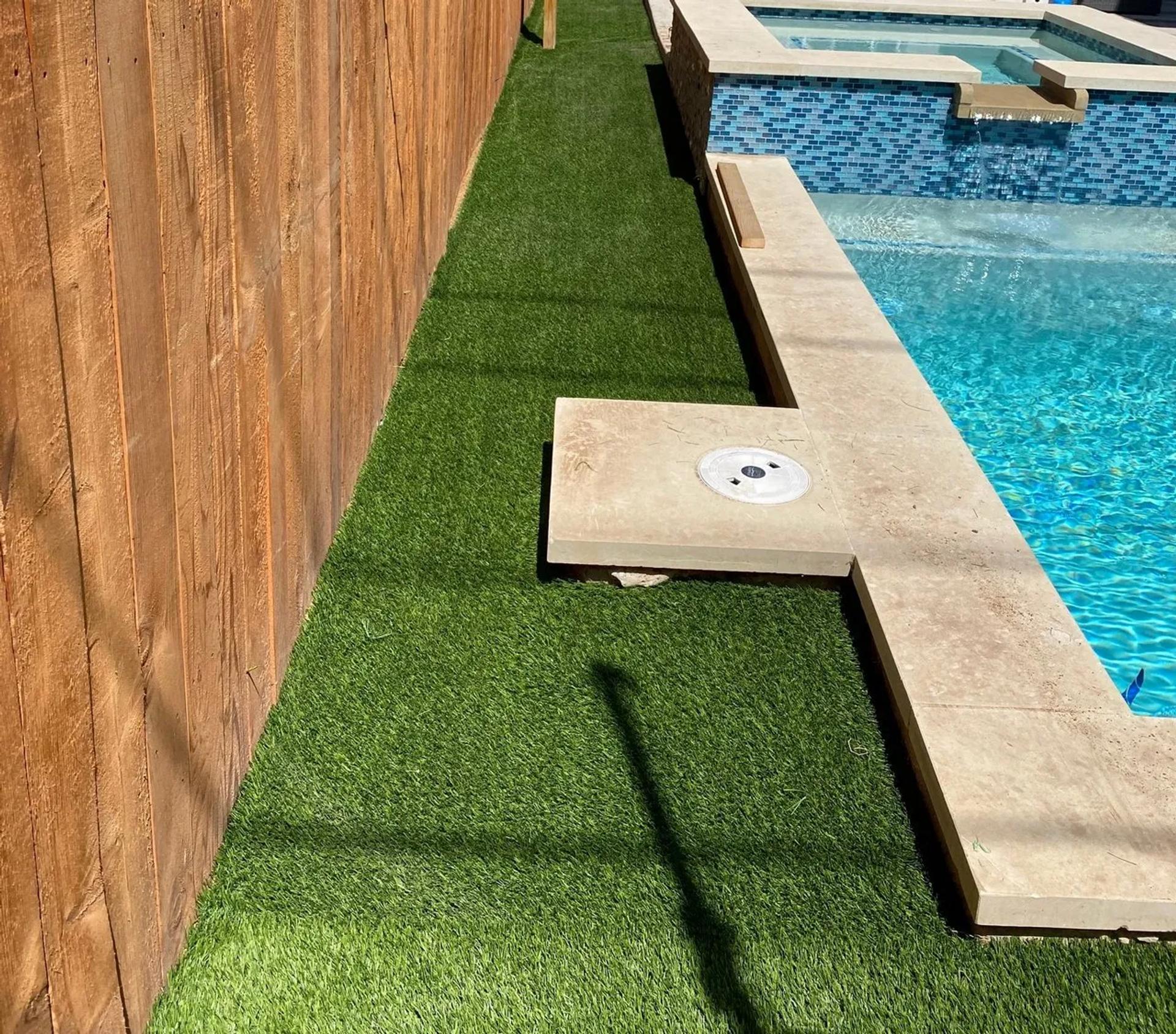 Pool next to artificial turf area