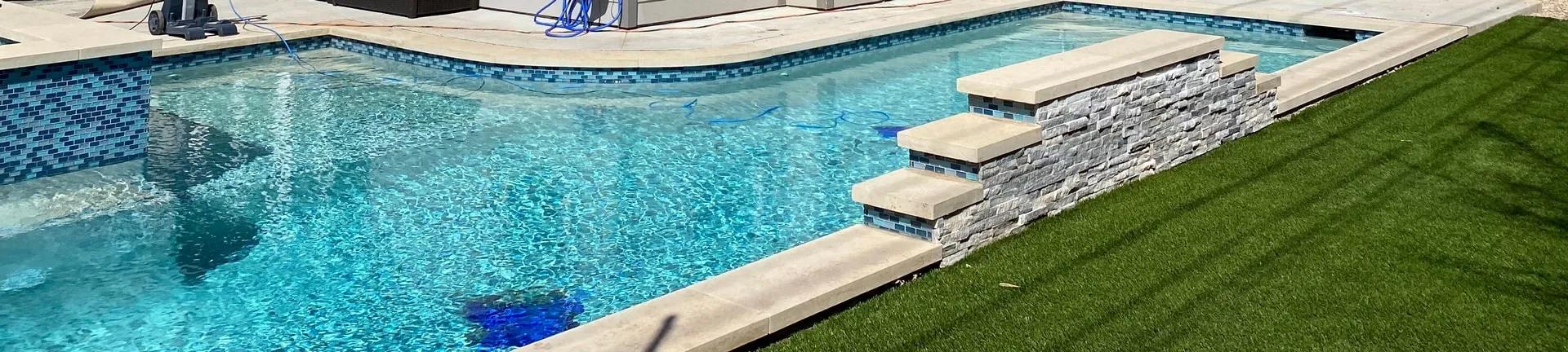 Pool next to artificial turf area