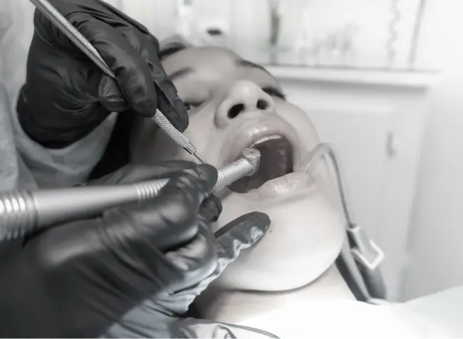 Dentist performing dental treatment to the patient