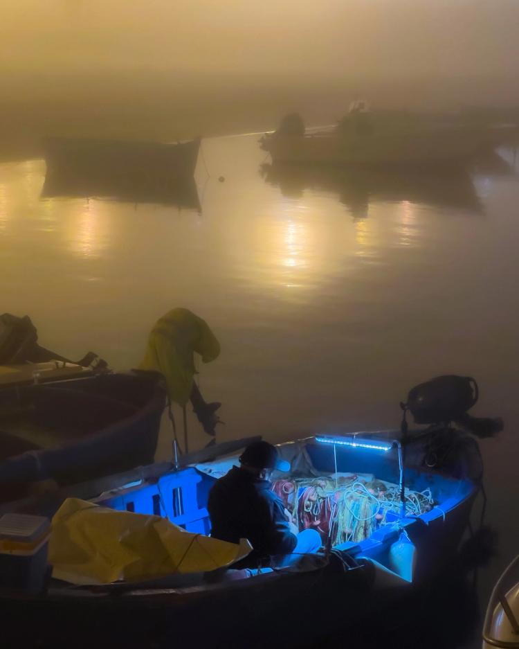 fisherman in boat at night