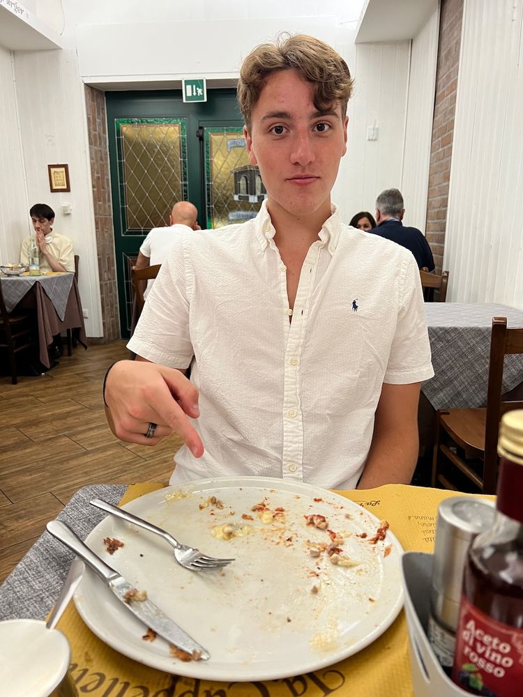 man pointing at empty plate