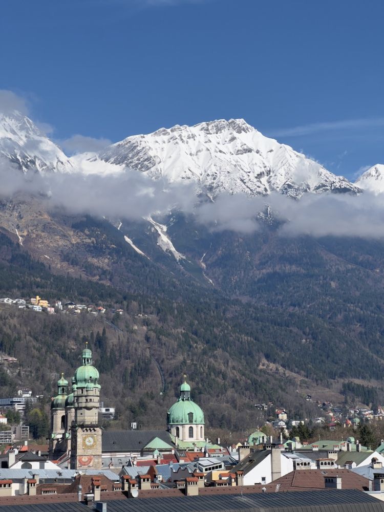 historic cathedral below mountains