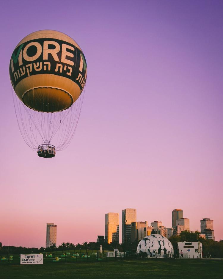 balloon over city at sunset
