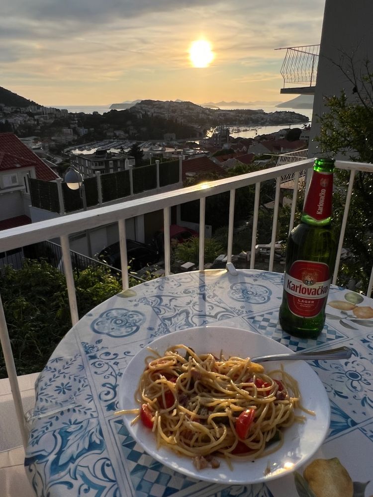 pasta and beer at sunset on balcony