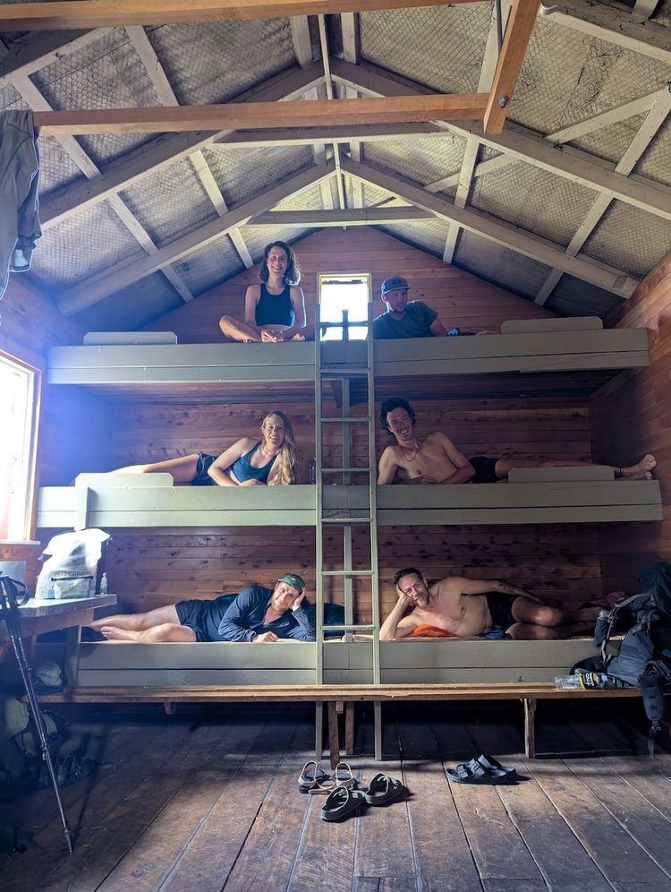 group of hikers posing in cabin