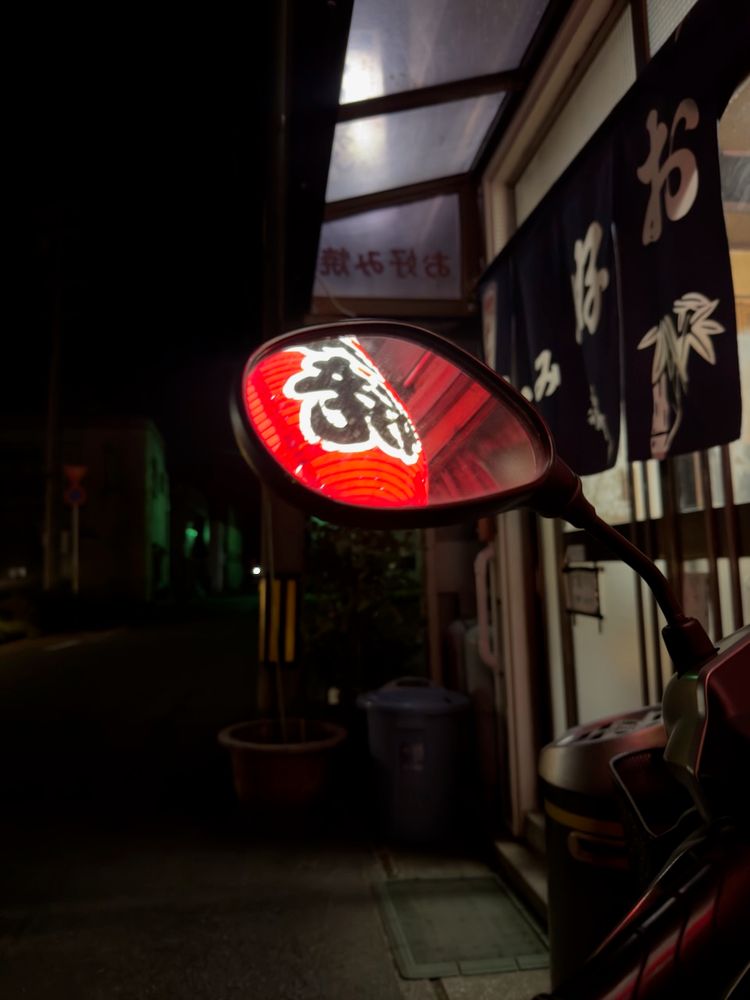 lantern reflected in motorbike mirror