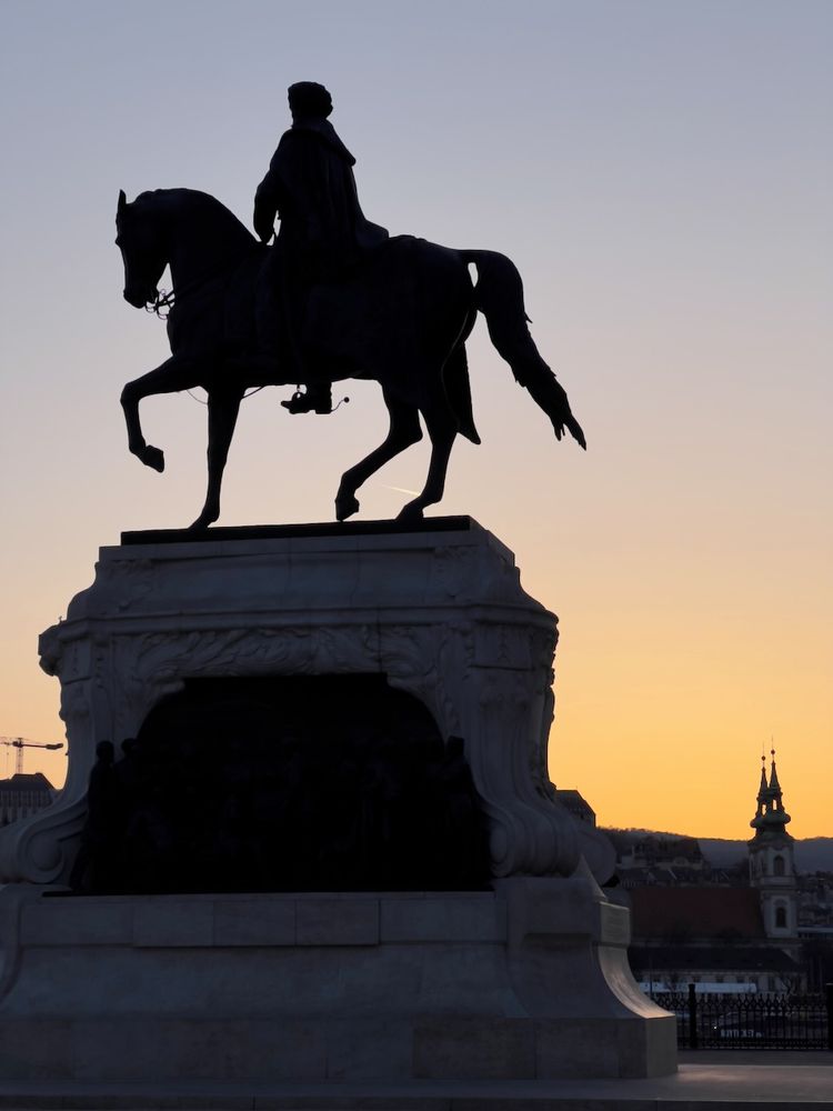 silhouette of statue at sunset