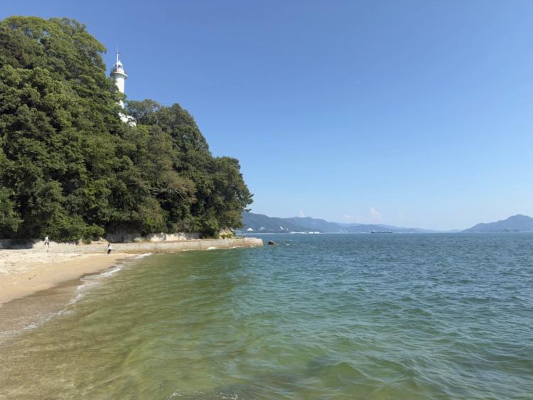 beach with lighthouse above