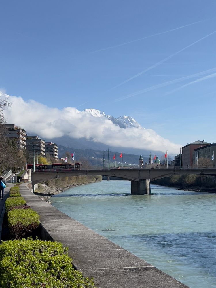 river with mountains shrouded in clouds behind