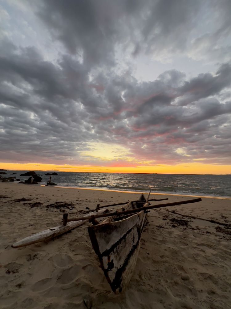 boat on beach at sunset