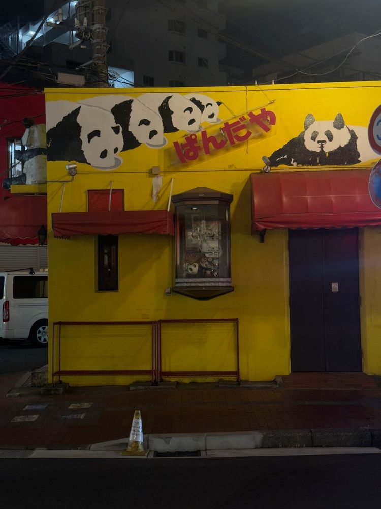 pandas painted on yellow building