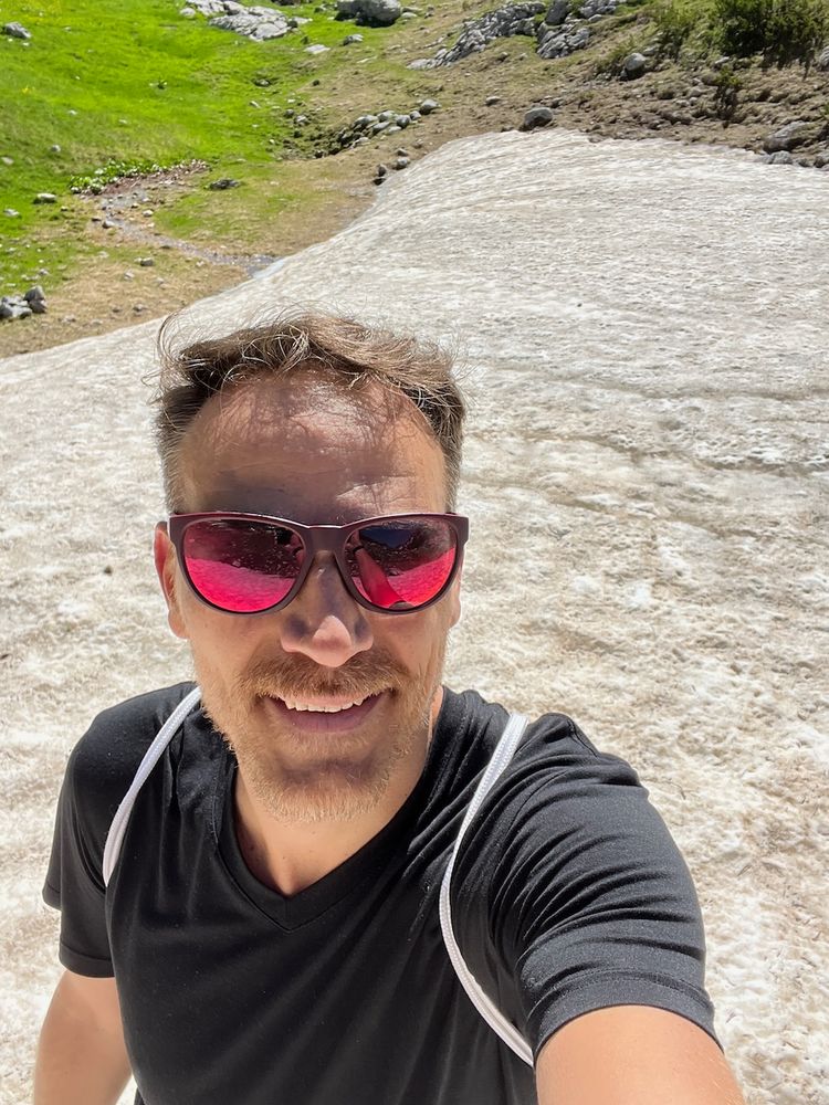 man walking on alpine snow