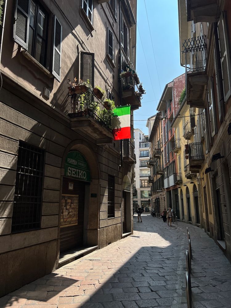 Italian flag hanging above street in milan
