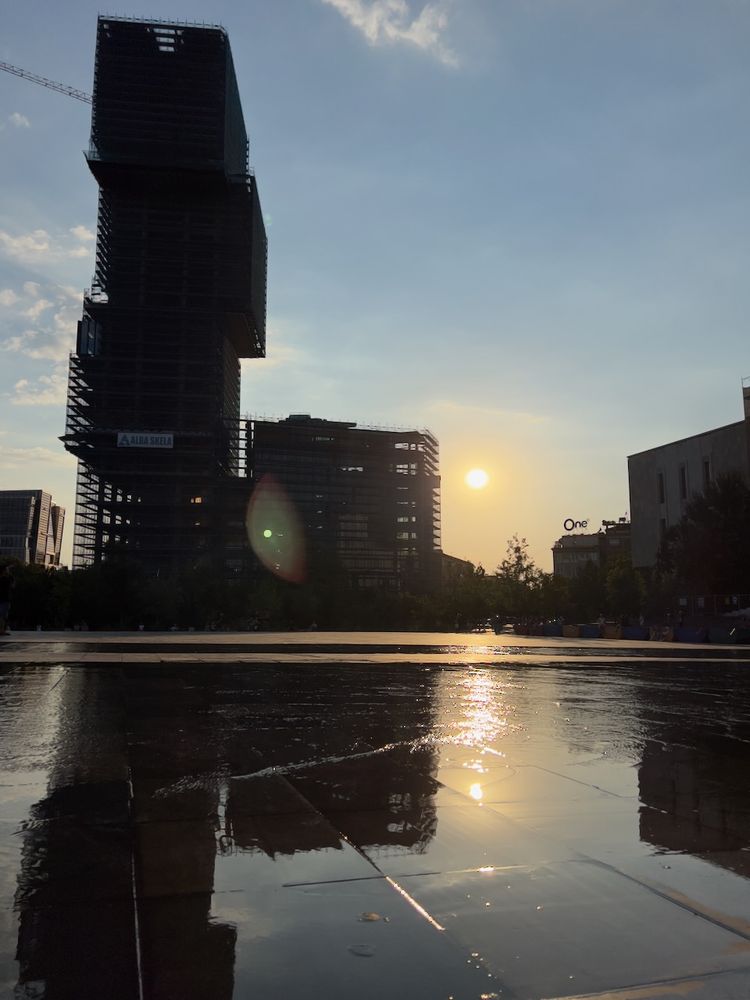 sunset reflection on water with building in background