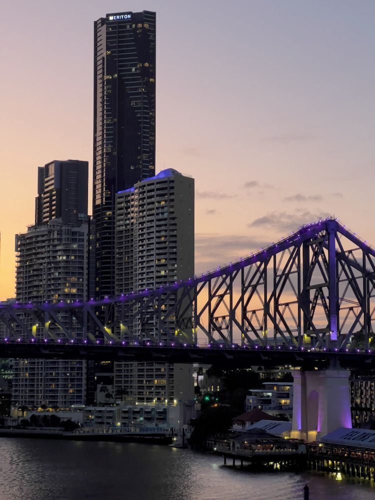 building and bridge at sunset