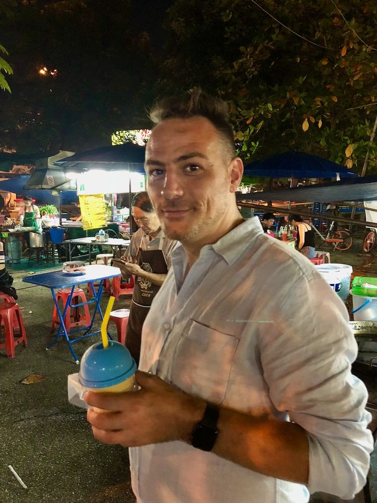 man standing in night market