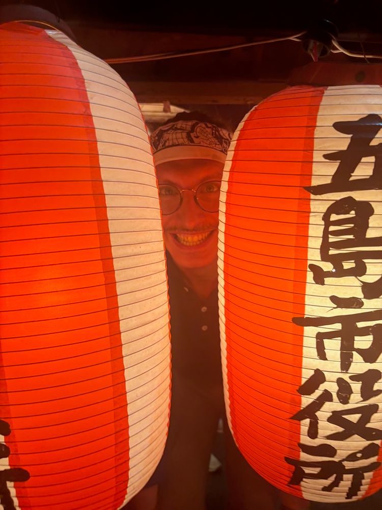 face glowing between lanterns