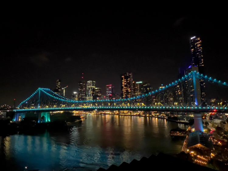 colorful city lights at night reflecting on river
