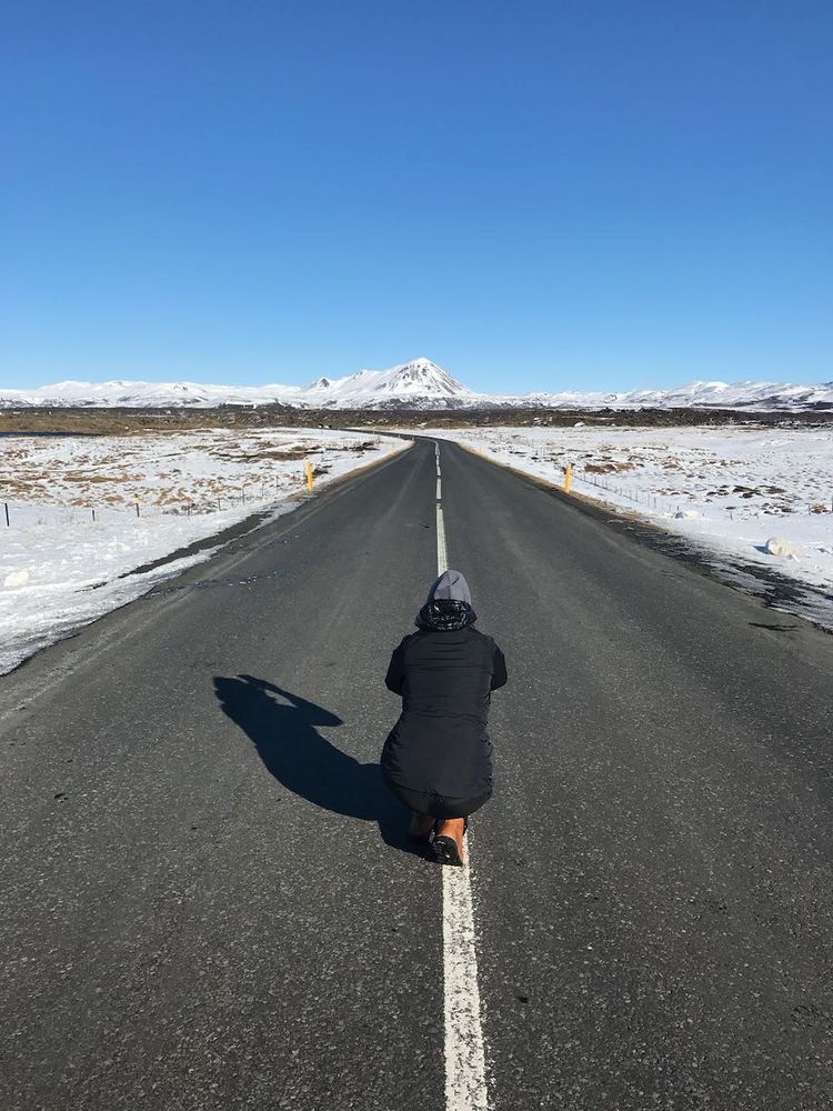 person taking photo of empty road