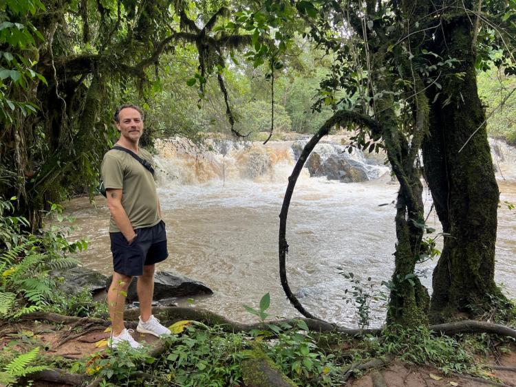 man by waterfall