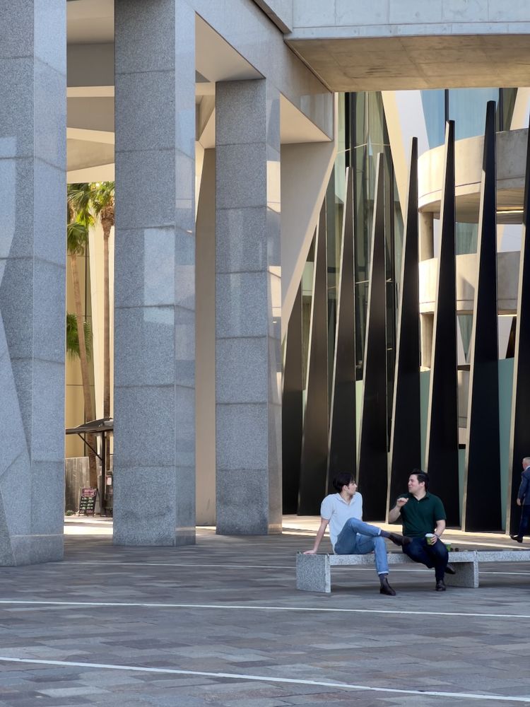 people on bench around architecture