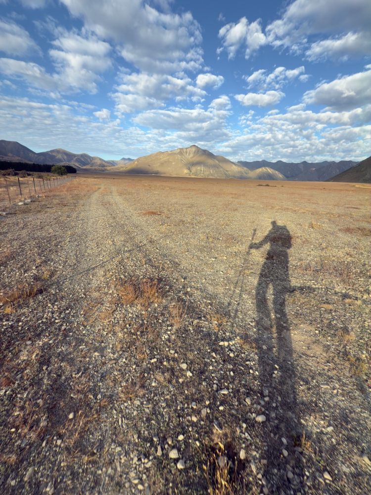 hiker's long shadow in morning sun