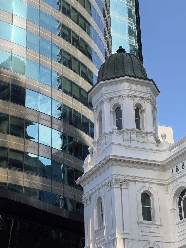 old building reflecting on new building