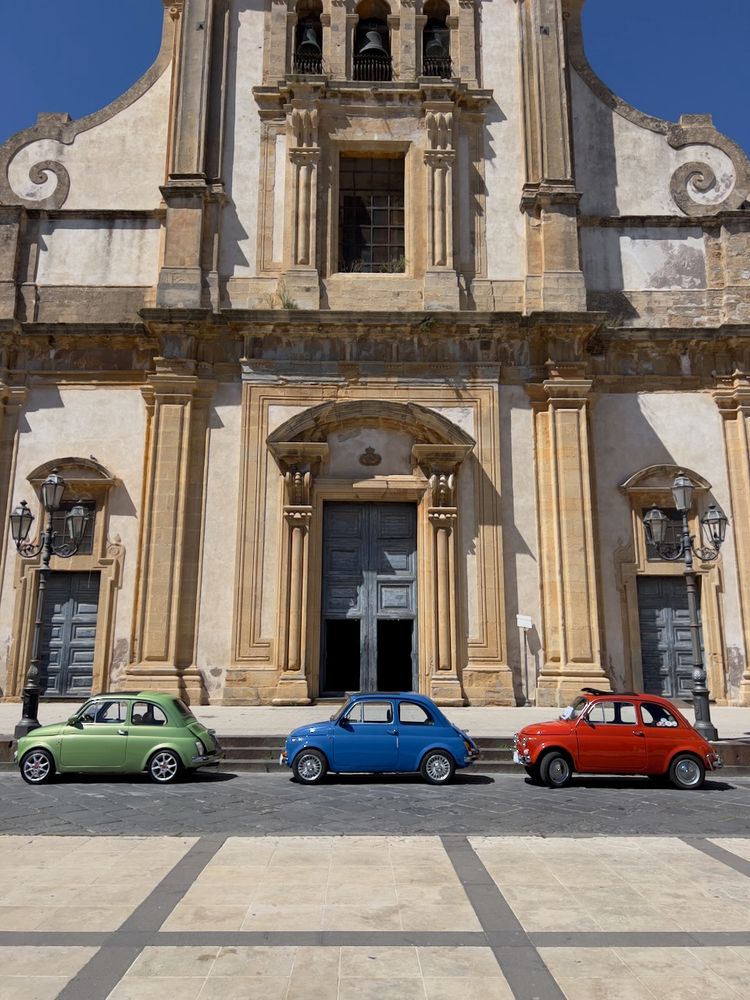 colorful cars in front of cathedral