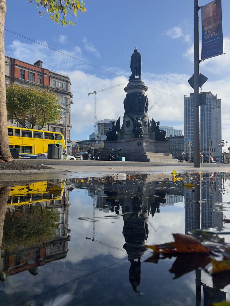monument reflected in puddle