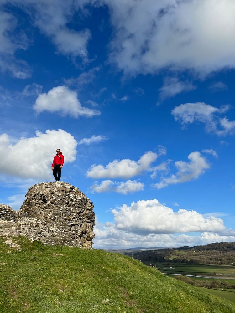 man on top of castle ruins