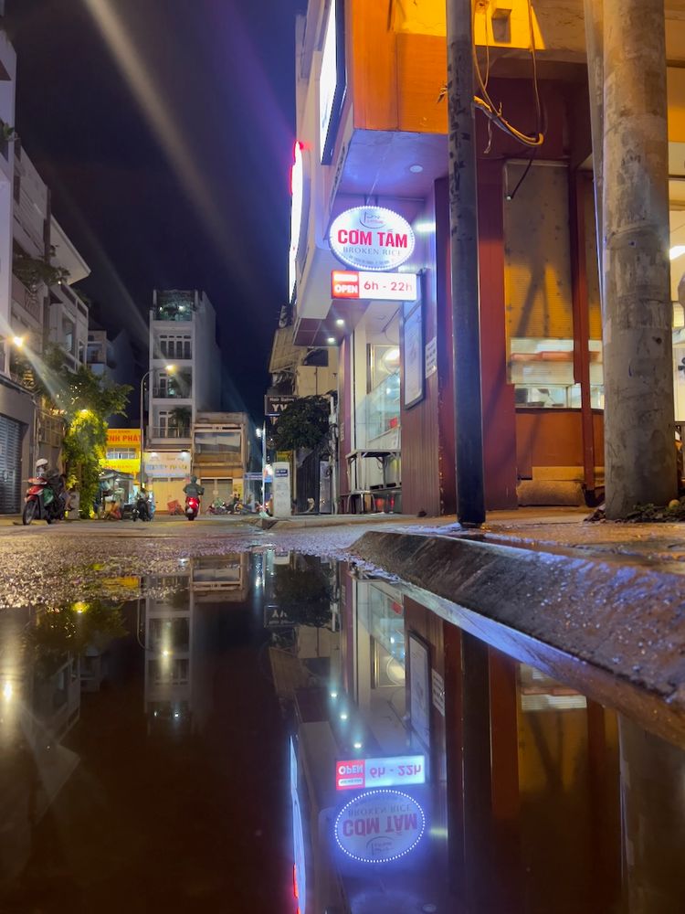 lights reflecting on street puddle