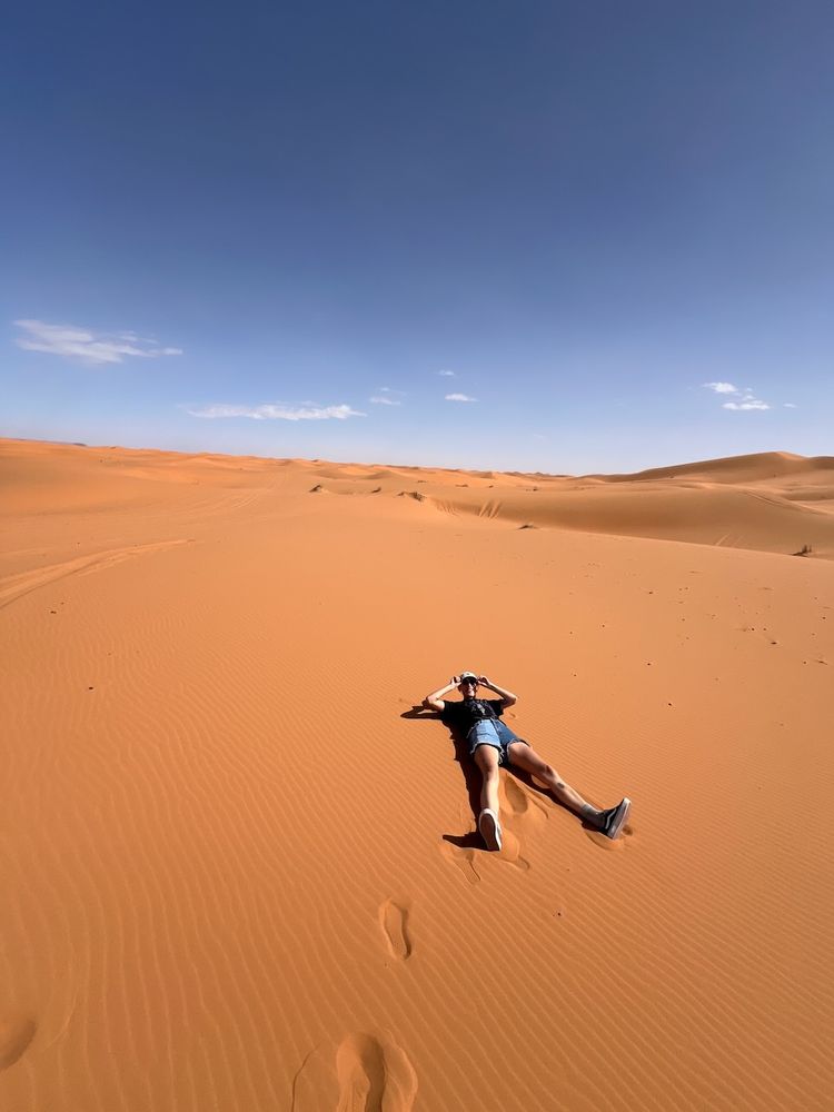 person laying in desert