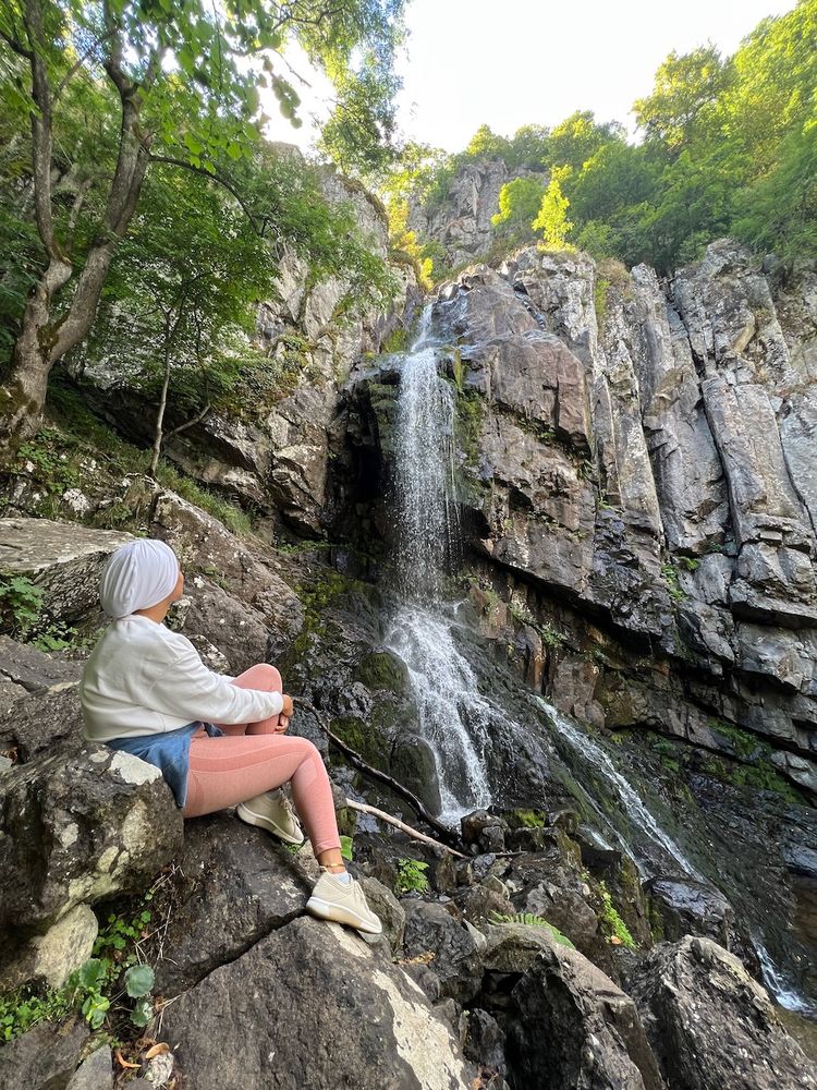 person enjoying view of waterfall