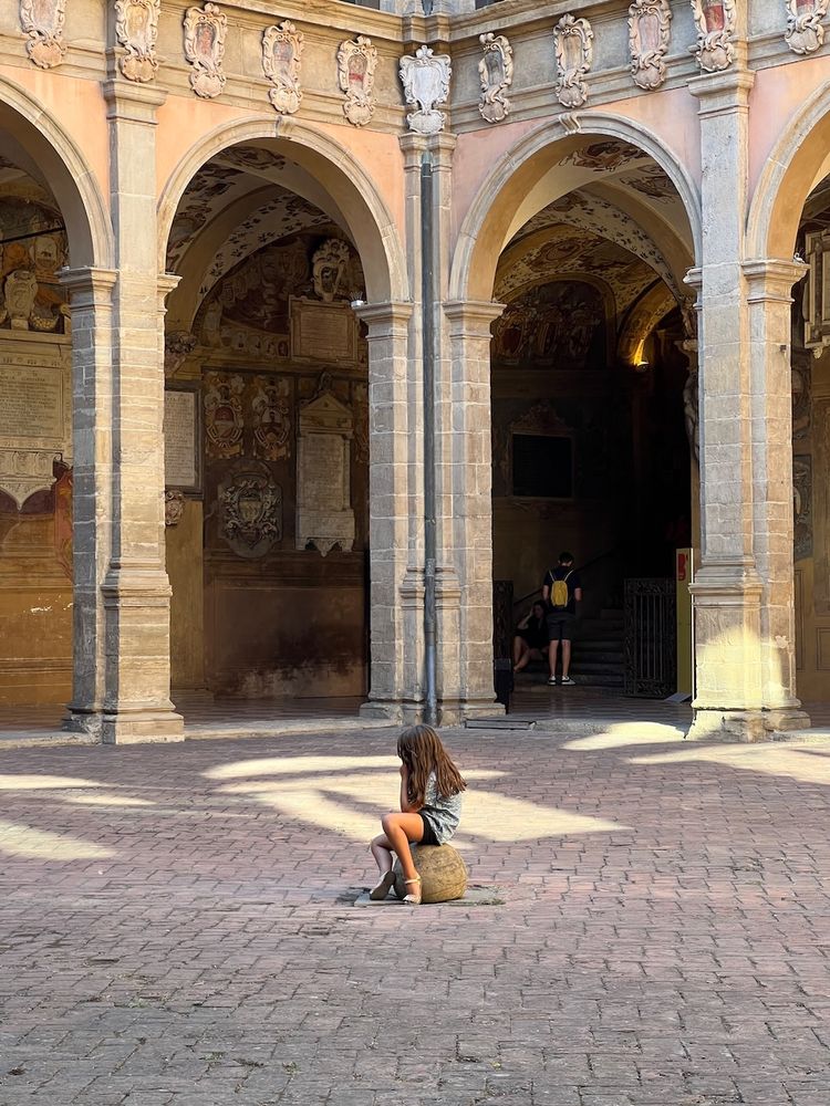 child sitting alone in piazza