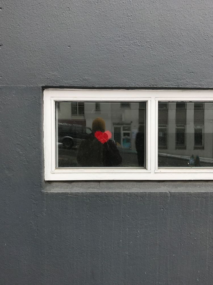 reflection with heart in window