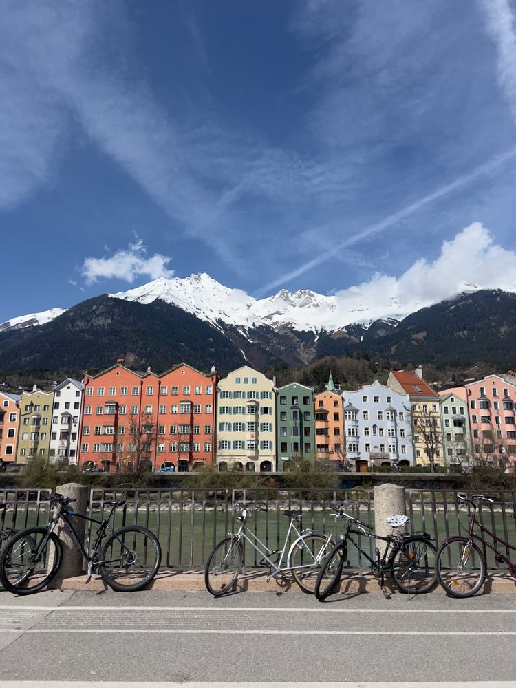 colorful buildings in front of snow capped mountains