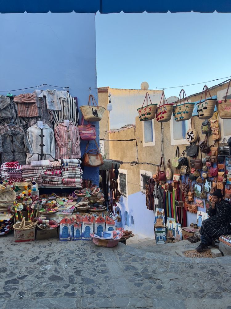 man selling his wares on colorful street