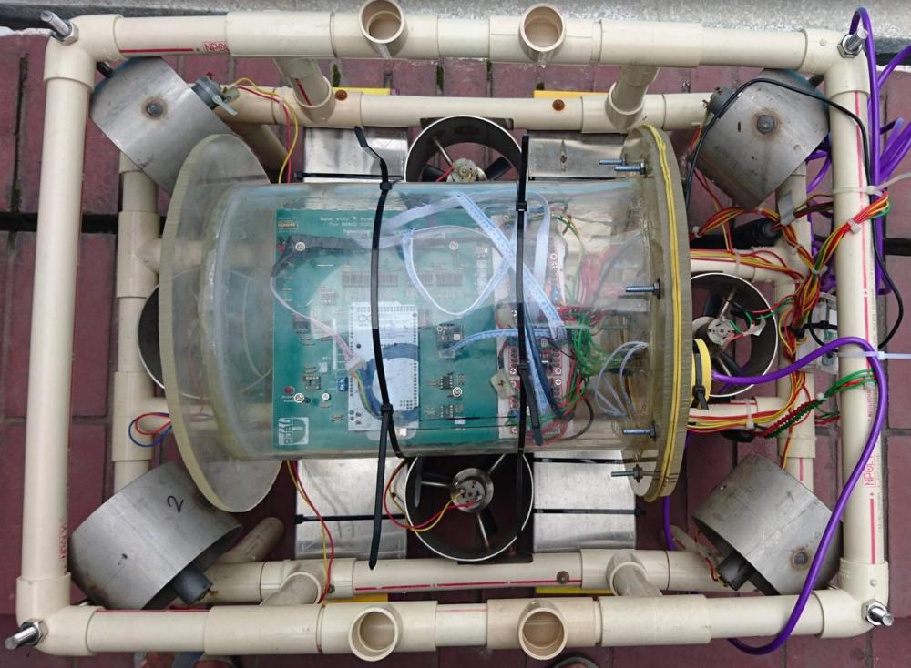 Overhead view of the frame with the transparent acrylic tube revealing the circuit board inside
