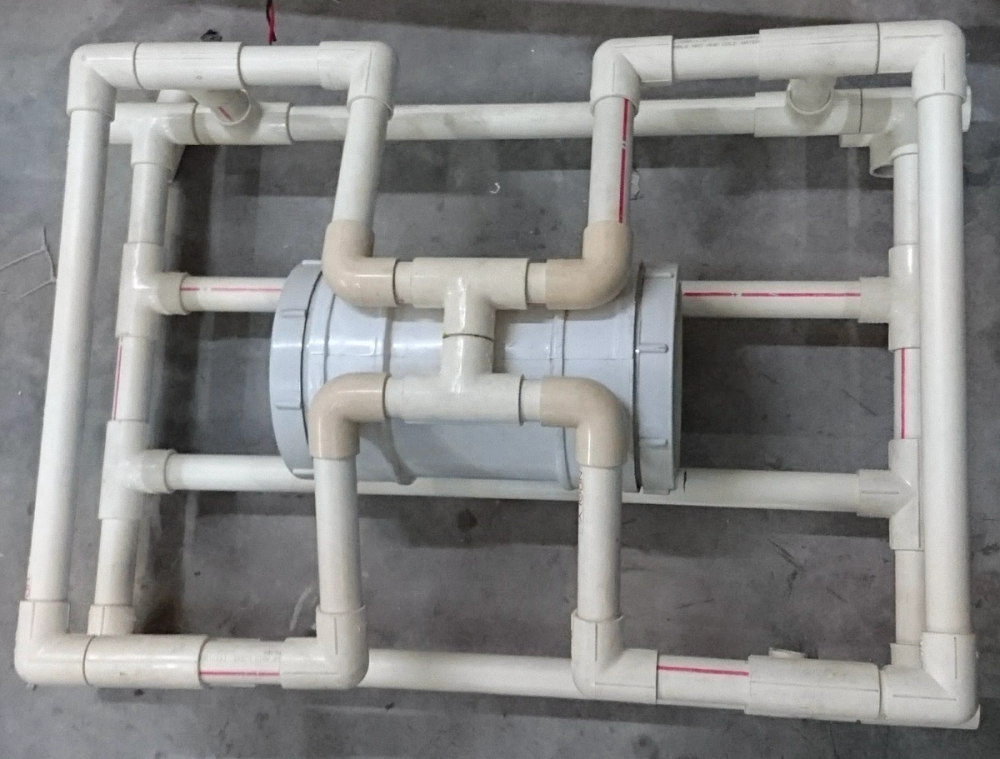 Overhead view of the PVC frame with the original white pipe fitting housing the electronics