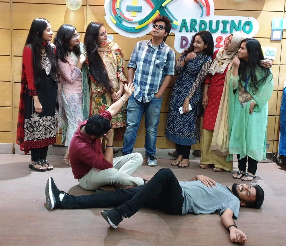 Riyad on the floor during a hangout, everyone gathered around