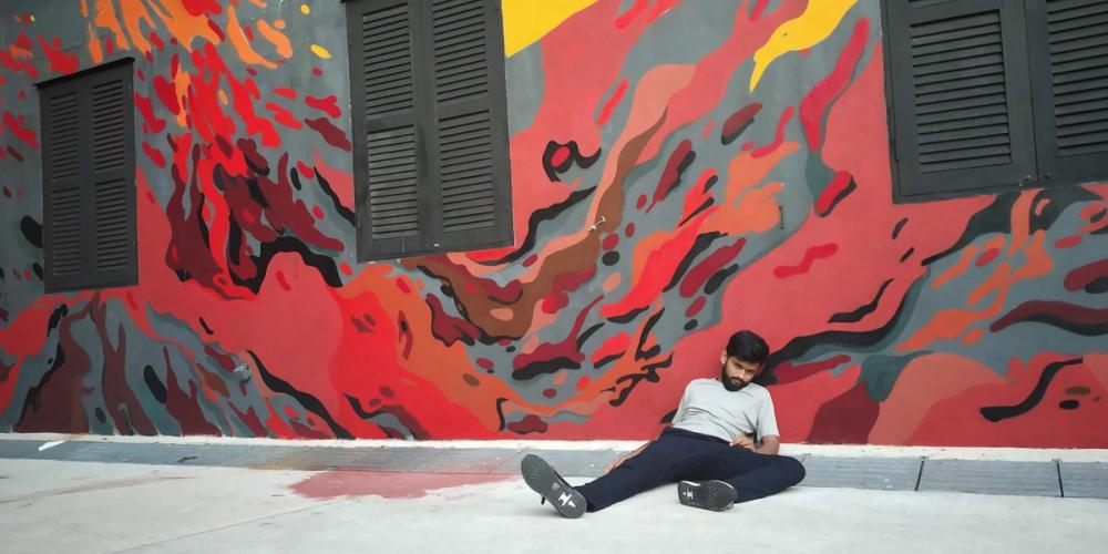 Arko lying on a street in Singapore for a photo