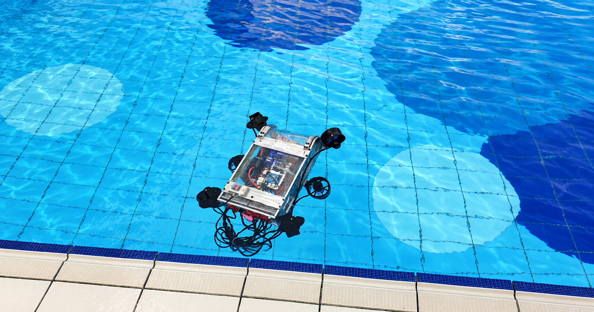 Duburi 2 floating in a bright blue swimming pool during testing before the Singapore AUV Challenge 2019