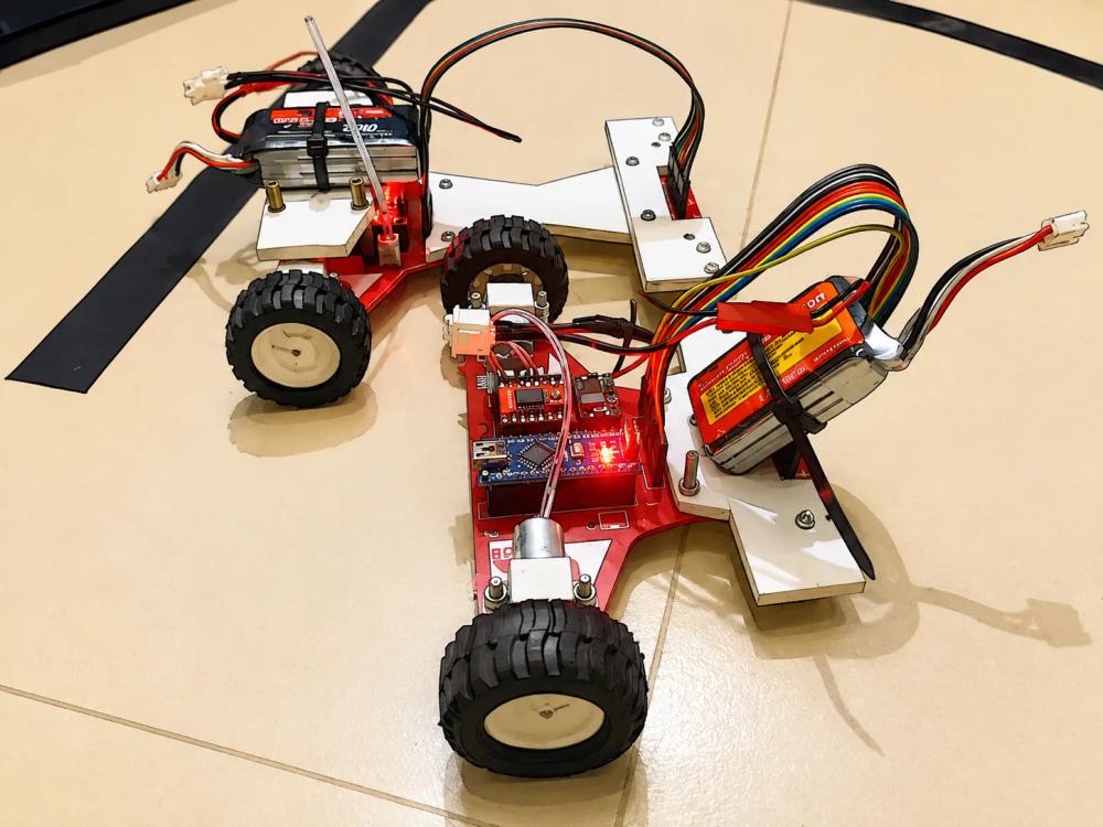 Two versions of Team LazyBot's line-follower robot side by side, 2018.