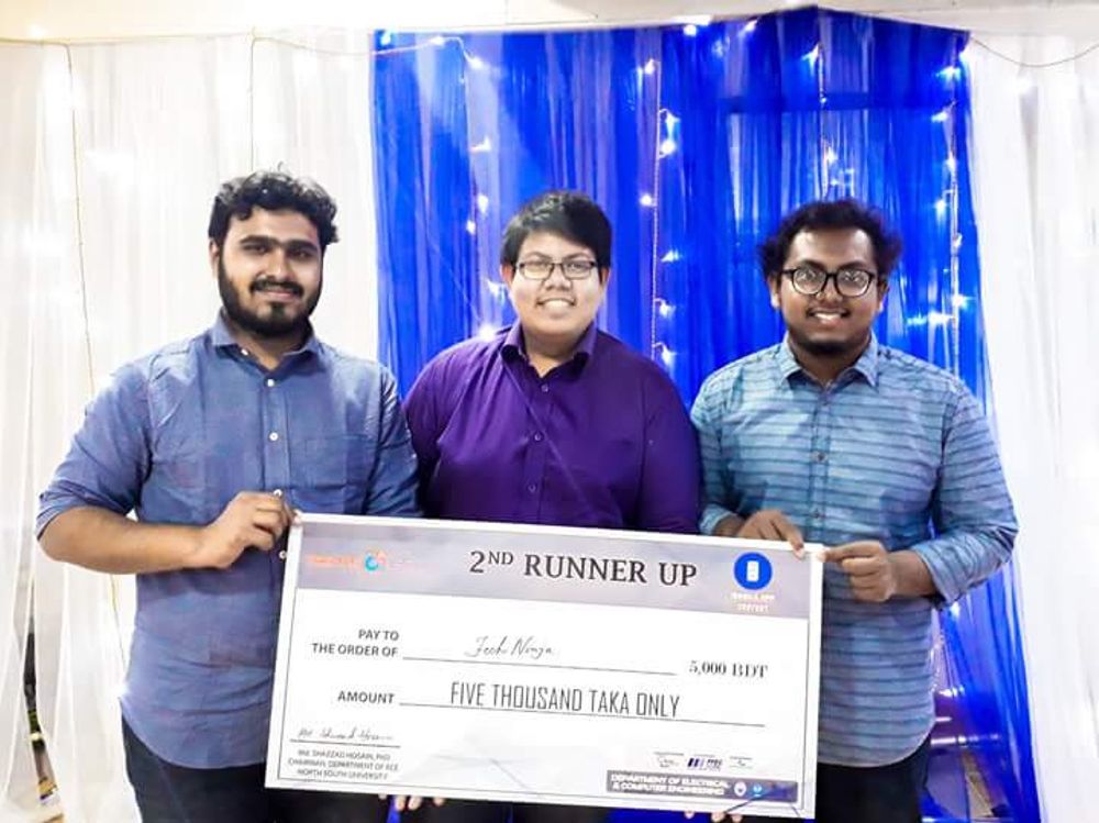 Rafat, Tridiv, and Ahnaf holding prize money from a competition