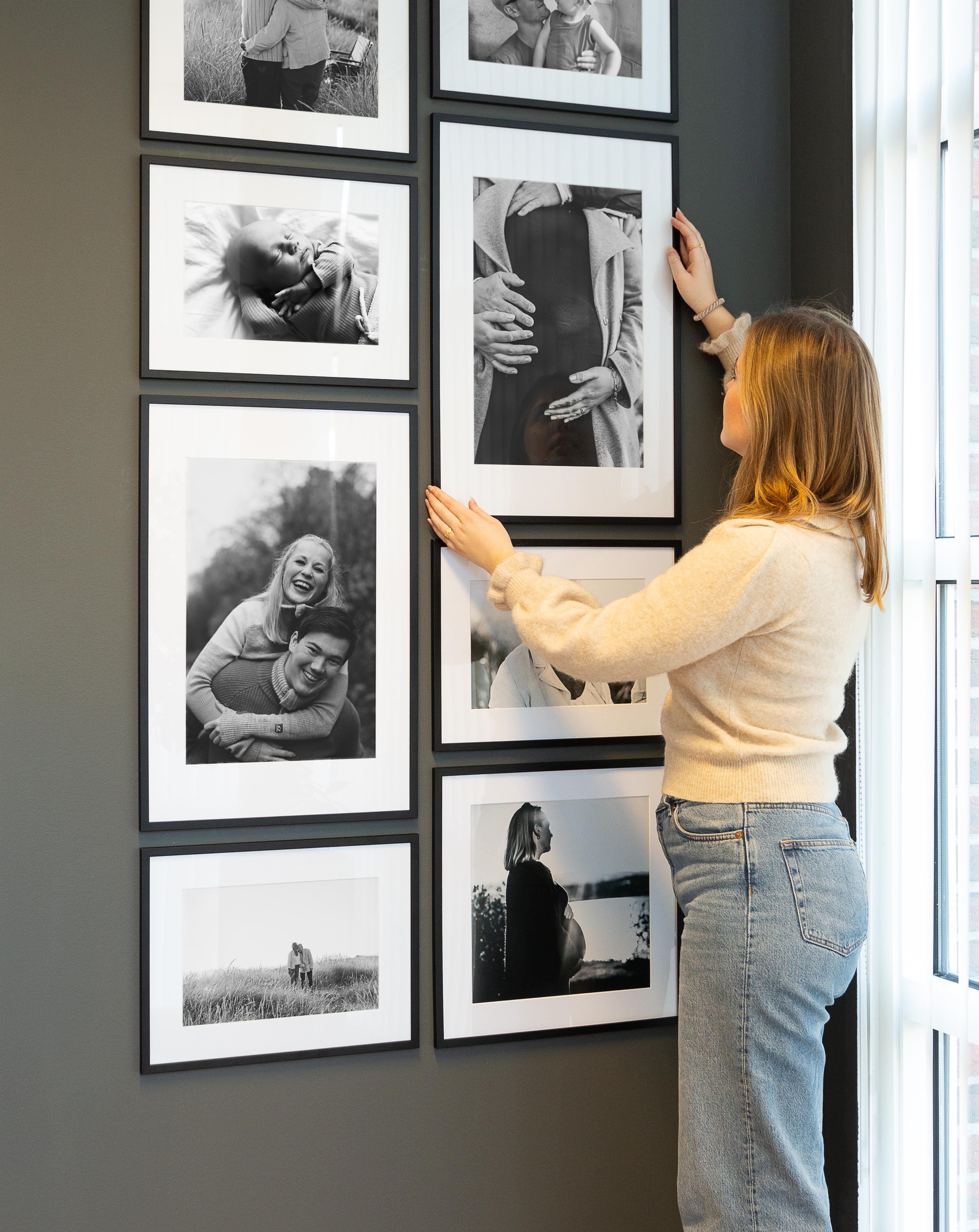 Bildevegg med sort hvitt bilder og passepartout