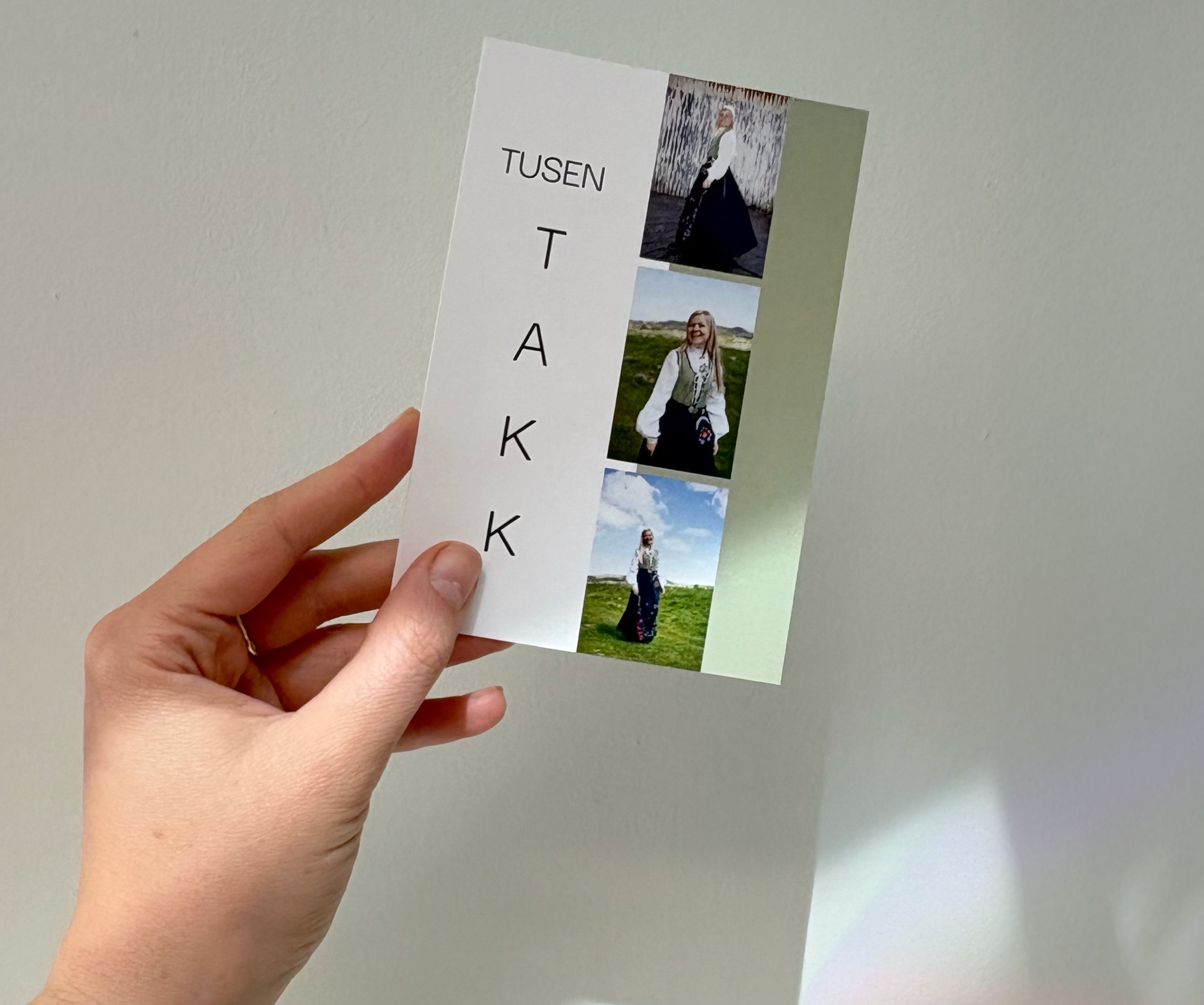 Ett takkekort med delvis grønn bakgrunn, bilder og teksten tusen takk, vises frem