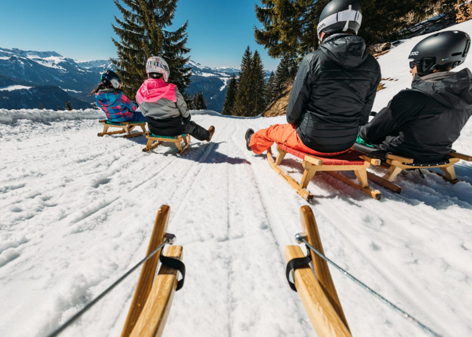 Family sledging down the toboggan run in St Anton