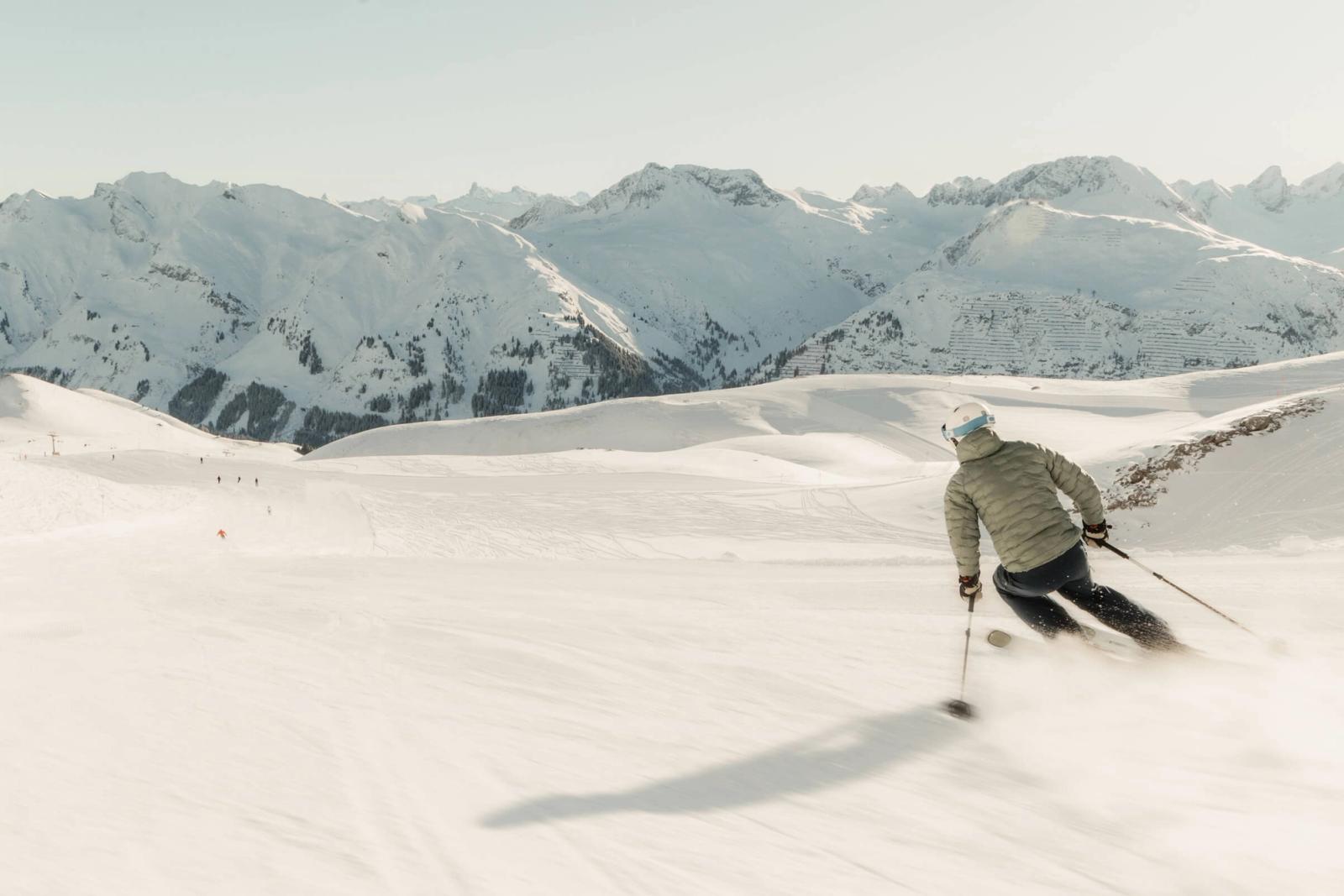 Skier in Lech on a quiet piste in the sun